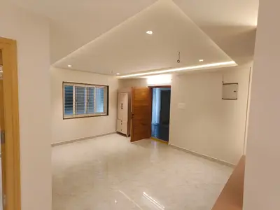 Entrance foyer of the Elite Homes 3 BHK sample flat with a panelled feature wall and the opening to the living room