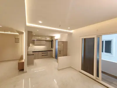 L-shaped kitchen of the Elite Homes 3 BHK sample flat with the service balcony door on the right