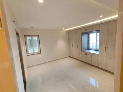 Master bedroom of the Elite Homes 3 BHK sample flat with wardrobe wall and window niche